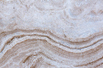 the texture of artificial marble is light natural beige with a beautiful pattern and dark inclusions.