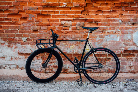 Customized commuter fixie bike at brick wall