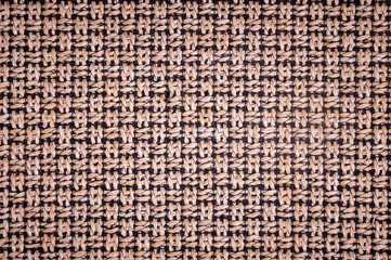 Textured background surface of textile upholstery furniture close-up. burlap brown color fabric structure