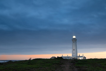 Fototapeta na wymiar Seal Point lighthouse at Cape St Francis at sunset
