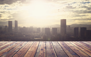 City concept: Wood table top on blur glass window wall building background