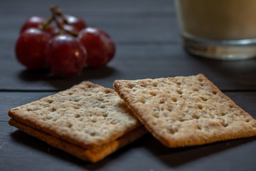 Breakfast with wholemeal cookies, fruits and drink on a rustic background.