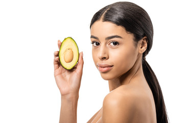 attractive naked african american woman holding avocado and looking at camera isolated on white