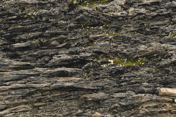 Textured basalt background thin stone fibers in the cut. natural volcanic formations
