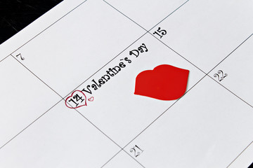 Calendar page with lips on February 14, Valentine's Day on a black background. Valentines day greeting card