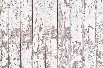 Old wooden plank with white peeling paint. Copy space for your text. Directly above.