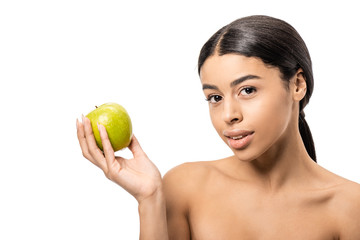 Obraz na płótnie Canvas beautiful young naked african american woman holding fresh apple and looking at camera isolated on white