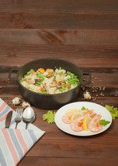 Aluminum non-stick cookware with vegetables on wooden background