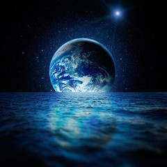 Fantastic space landscape. Planet Earth is reflected in the waters of the ocean with a myriad of...