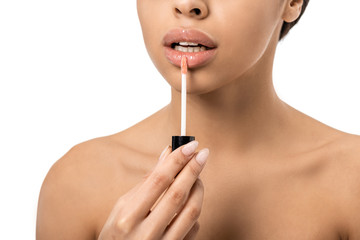 cropped shot of naked young african american woman applying lip gloss isolated on white