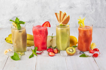 smoothies with fruit on a white wooden backdrop