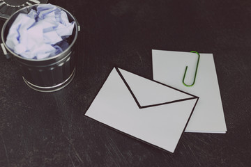 envelope with clip symbol of email and attachments with trash can next to it
