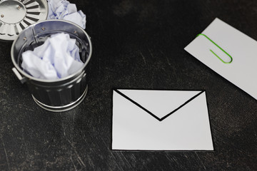 envelope with clip symbol of email and attachments with trash can next to it
