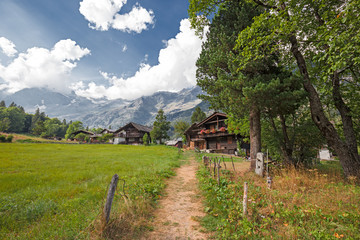 Path through the meadows of the Anzasca Valley in Macugnaga on the slopes of Monte Rosa in...