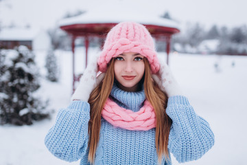 Close up winter portrait of young positive happy freedom hipster caucasian pretty fashionable girl outdoors in winter park smiling and having fun