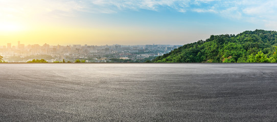 Panoramic city skyline and buildings with empty asphalt road at sunrise - Powered by Adobe