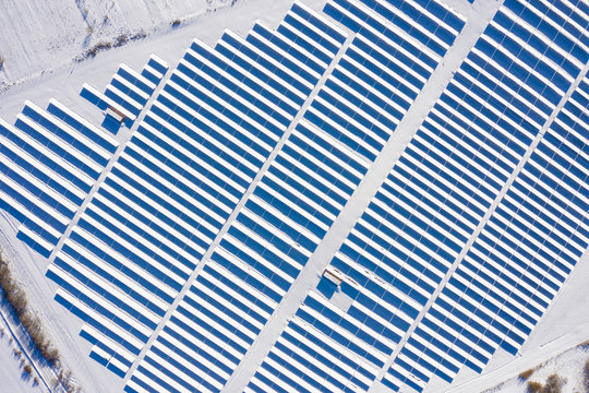 Aerial image of snow covered solar panel park