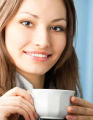 Cheerful smiling business woman with coffee