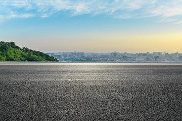 Fototapeta premium Panoramic city skyline and buildings with empty asphalt road at sunrise
