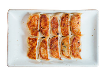 Isolated Top view of Yaki-Gyoza set (Japanese Pan-Fried Dumplings) served on white plate.