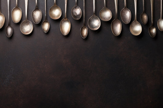 Old Vintage Spoons On Stone Table