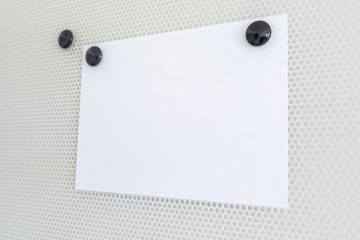 Blank piece of white paper on a magnetic board