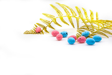 Easter eggs pink, blue color and gold fern branches isolated on white background