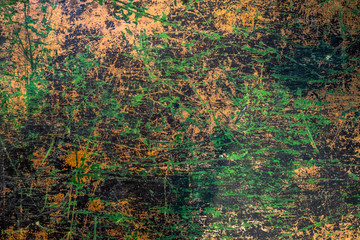 Background of green and black scratched paint. Vintage look backdrop. Pastel brown and green tones.