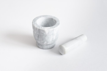 Marble mortar, pounder and pestle on white background
