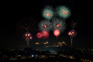 Firework sparkling in dark sky on temples over  the hills at Phra Nakhon Khiri, Khao Wang, Phetchaburi, Thailand. Khao Wang fireworks Festival