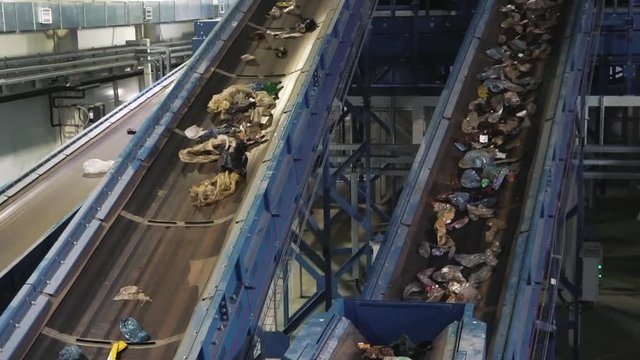 Waste processing plant. Waste on shipping tape. Waste sorting