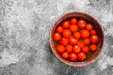 Pickled tomatoes in a bowl.