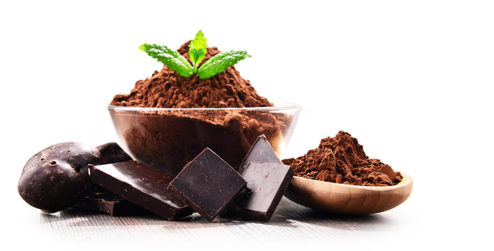 Composition with bowl of cocoa powder isolated on white