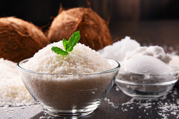 Composition with bowl of shredded coconut and shells