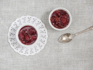Homemade strawberry sweet delicious jam with whole berries on white background. Top view