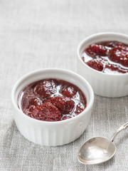 Homemade strawberry sweet delicious jam with whole berries on white background