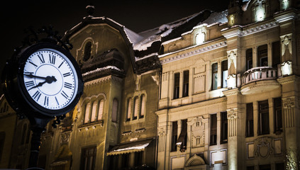 Fototapeta na wymiar Old clock night city outdoor arhitecture