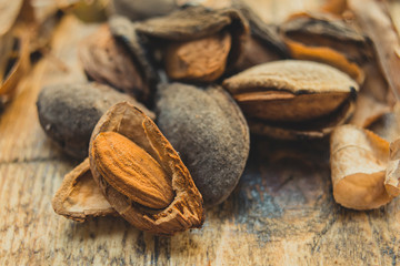 Almonds on wooden board close up