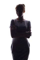 silhouette of a beautiful girl confidently looking forward, figure of young woman on a white...