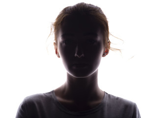 silhouette of a girl confidently looking forward, a young woman's head with a curl on a white isolated background