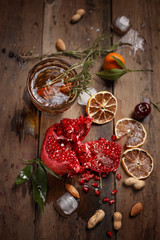 Fragrant fruit tea with tangerines, dried lemons and rosemary on a wooden table. Country style.