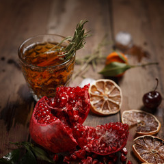 Fragrant fruit tea with tangerines, dried lemons and rosemary on a wooden table. Country style.