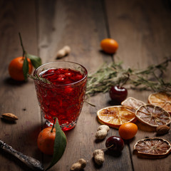 Pomegranate juice with pomegranates and dried fruits on a wooden table. Country style.