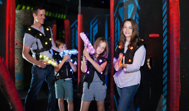 Woman with daughter playing laser tag