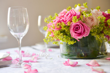 floral arrangement for interior decoration, table setting for a wedding or to create a home cosiness. use as background. pink roses