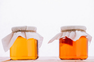 bottled organic kombucha mushroom with tea in jars isolated on white