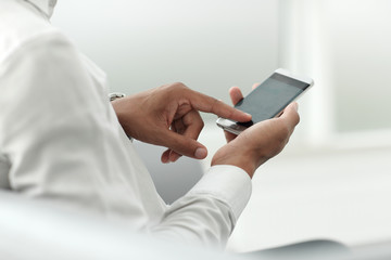 close up. modern man typing on his smartphone.
