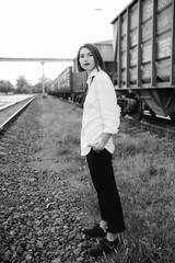 Portrait of woman posing at the railway station and looking at the camera