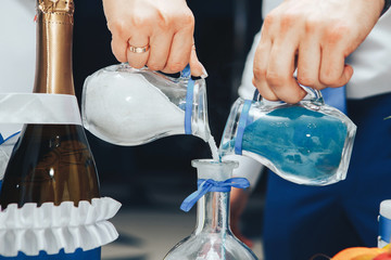 mixing colored sand in a bottle