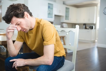 Worried man sitting at home